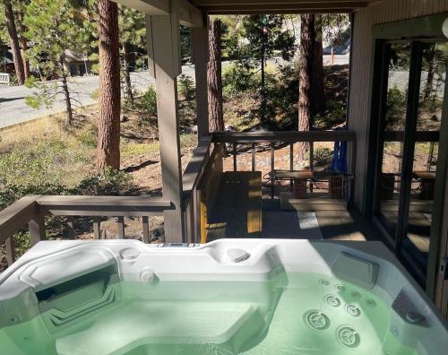 a bath tub on the porch of a house at Gale Force Wind home in Incline Village