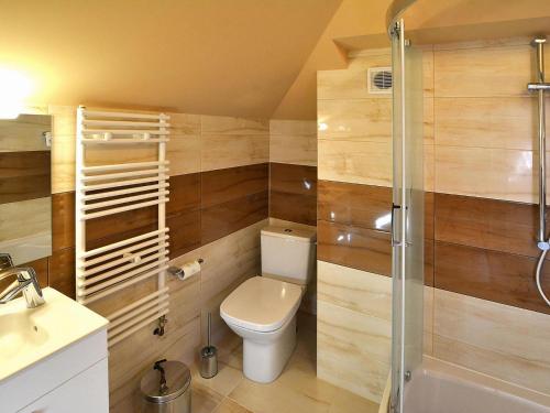 a bathroom with a toilet and a shower at Semi-detached house, Mielno in Mielno