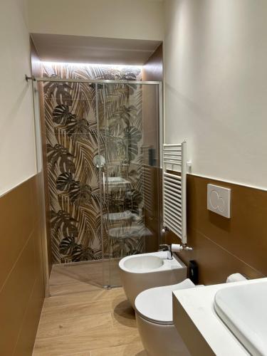 a bathroom with a shower and a toilet and a sink at ALBARI HOUSE in Bologna