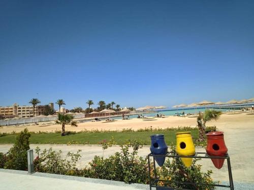 a view of a beach with three colorful vases at Scandic Resort One Bedroom Apartment in Hurghada