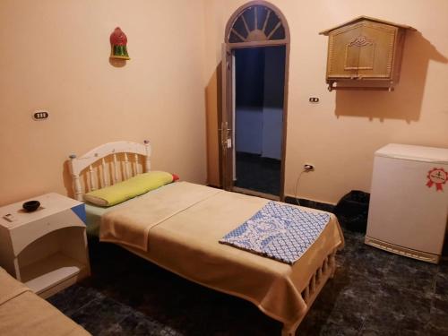 a small room with a bed and a couch at Oasis Panorama Hotel in Bawiti