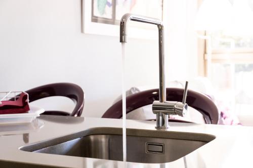 a kitchen sink with a faucet on a counter at Apartamento - Riba De Sella in Ribadesella