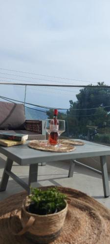 a table on a balcony with a view of the ocean at Wide Blue Luxury Boutique Suites in Neos Marmaras