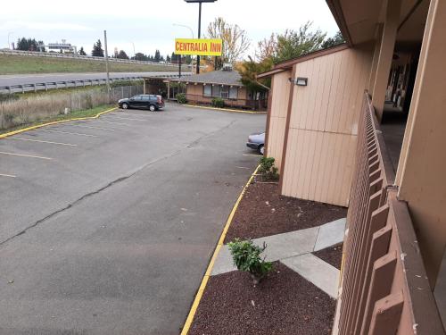 a parking lot with a car parked next to a building at Centralia Inn in Centralia