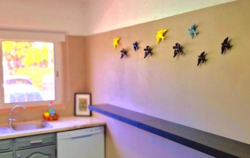 a kitchen with star decorations on the wall at Seaside SunFlower in Quinta do Lago