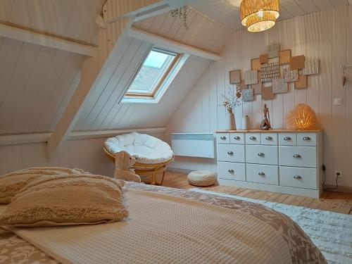 ein Schlafzimmer mit einem Bett, einer Kommode und einem Fenster in der Unterkunft L'Escale Portaise in Port-en-Bessin-Huppain