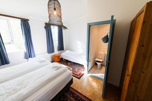 a hotel room with a bed and a bathroom at Hótel Goðafoss Fosshóll in Godafoss