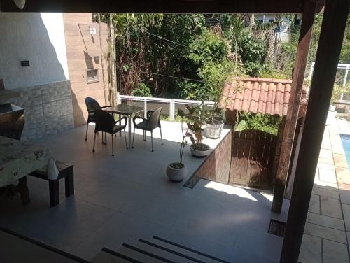 a view of a patio with a table and chairs at Mata Virgem Hostel e Pousada in Abraão