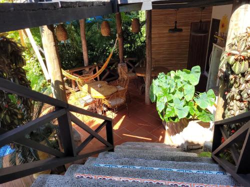 a view of a porch with a table and chairs at Hostal Antawara Tayrona in El Zaino