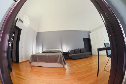 a bedroom with a bed and a living room at Dimora Notar Domenico -GRAVINA IN PUGLIA- in Gravina in Puglia