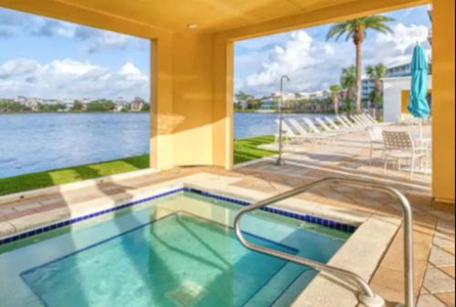a swimming pool with a view of the water at New Listing: Water Views, Beach, West end near 30A in Panama City Beach