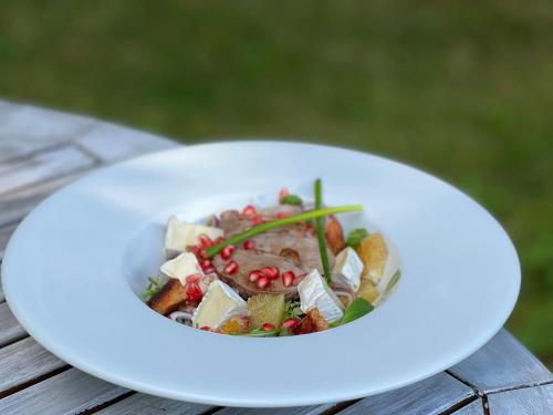 a white plate of food on a wooden table at Hotel i Restauracja Castle in Bystrzyca Kłodzka