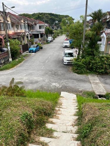 a street with cars parked on the side of the road at Iwan Ila Homestay in Batang Kali