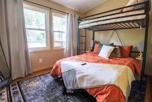 a bedroom with a bed and a bunk bed at Serenity on Montclair - Groups/Games/FastWiFi in Birmingham