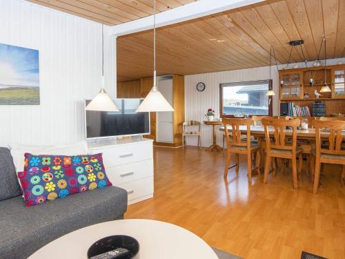 a living room with a couch and a dining room at 8 person holiday home in Aabenraa-By Traum in Aabenraa