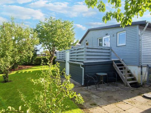 a tiny house with a porch and a patio at 8 person holiday home in Aabenraa-By Traum in Aabenraa