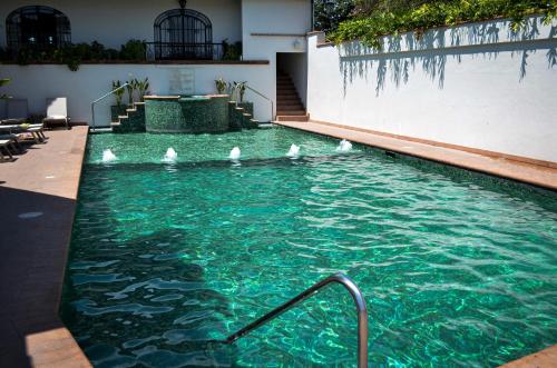 a swimming pool with white birds in the water at Hotel Agua Escondida in Taxco de Alarcón