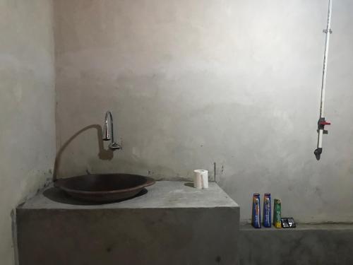 a bathroom with a bowl sink on a counter at Muni's Lombok Bungalow in Masbagik