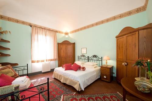 a bedroom with a bed with red pillows on it at Angelica by PosarelliVillas in Molino Mazzetti