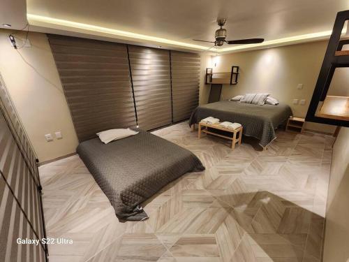 Ένα ή περισσότερα κρεβάτια σε δωμάτιο στο Casa Beily con alberca climatizada