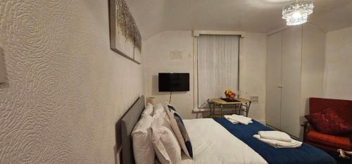 a bedroom with a bed and a couch and a television at Lawnswood Apartments in Blackpool