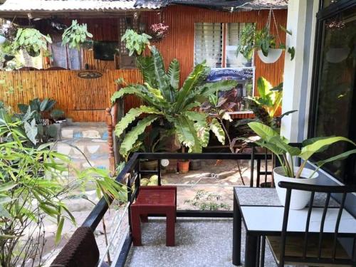 a patio with plants and a table and chairs at Tiny House Loft Style in Digos