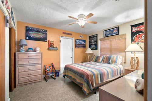 a bedroom with a bed and a dresser at Parrot Bay Retreat in Sarasota