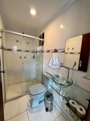 a bathroom with a blue toilet and a sink at Residencial Ribeiro in Salvador