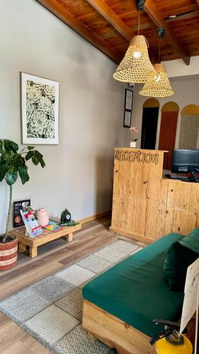 a living room with a bed and a wooden partition at Luum Casa Hotel Manila in Medellín