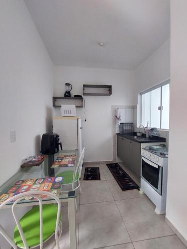 a kitchen with a table and chairs in a room at Apartamento Aconchegante in Brotas