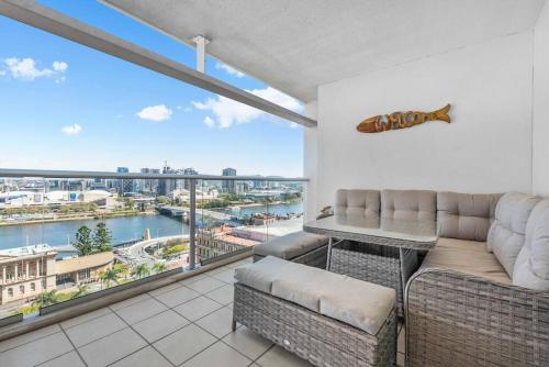 a living room with a couch and a large window at Dress Circle! 2Bed/2Bath/1Car/Amazing Views ~ CBD in Brisbane