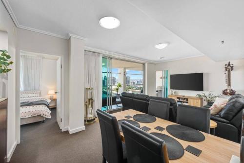 a living room with a dining room table and a couch at Dress Circle! 2Bed/2Bath/1Car/Amazing Views ~ CBD in Brisbane