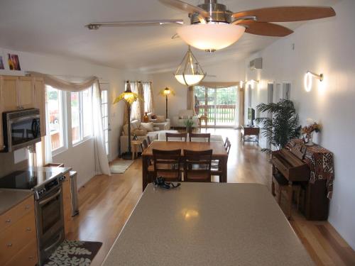 a kitchen and living room with a table and a dining room at Itʻs All About the Beach in Hauula