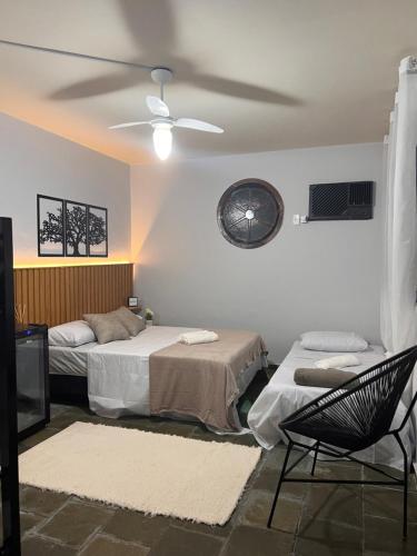 1 dormitorio con 2 camas y TV. en Casa da Lola en Angra dos Reis