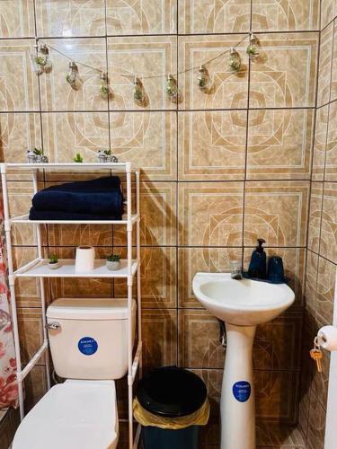 a bathroom with a toilet and a sink at Casa Nicolas #1 in San Pedro La Laguna