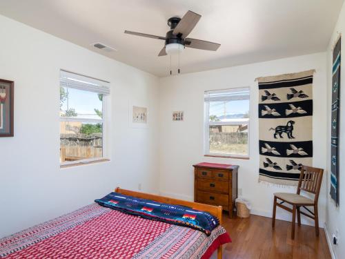 a bedroom with a bed and a ceiling fan at Chicos Hideaway in Santa Fe