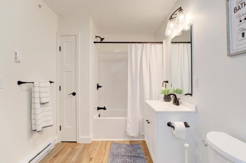 a white bathroom with a tub and a sink at Cozy Escape with Modern Comfort in Central Auburn - 1BD, 1BA Apartment in Auburn