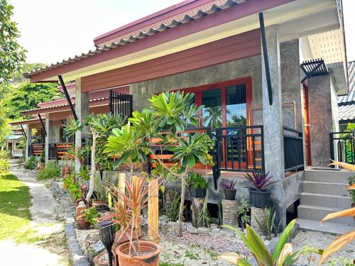 a house with plants in front of it at Ibiza Bungalows in Haad Yao