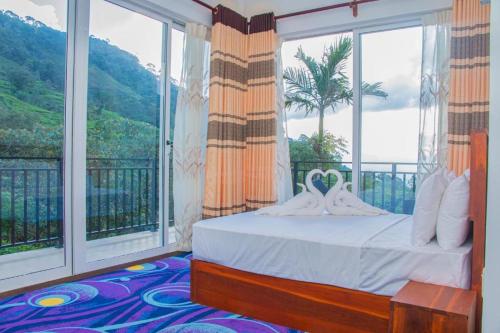 a bedroom with a bed and a large window at Sinharaja Tea Garden Hotel in Rakwana