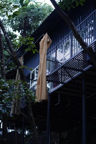 a towel hanging on the side of a house at The Hillock-quiet by the Mountains in Vallikavungal