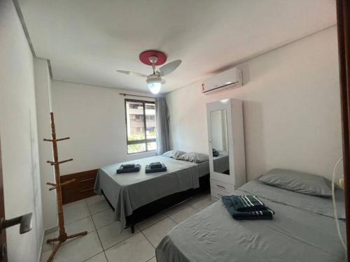 1 dormitorio con 2 camas y espejo en Apartamento a 4min da praia em Tambaú-João Pessoa, en João Pessoa