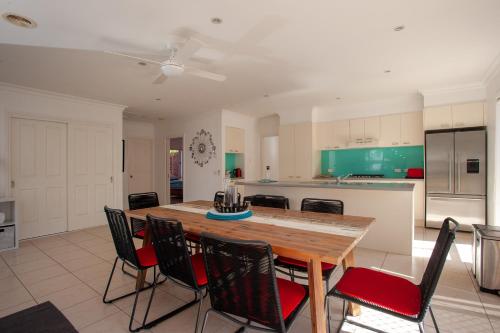 a kitchen with a wooden table and chairs at R&R by the Bay in prime location in Dromana