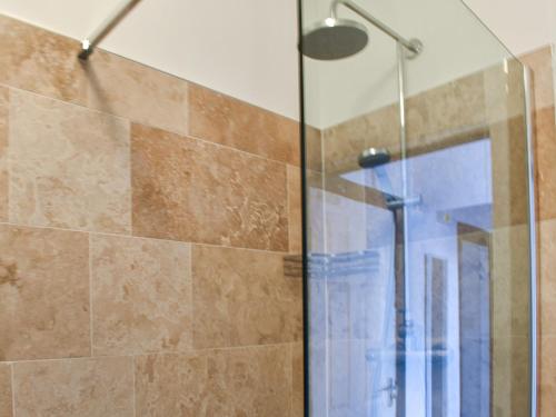 a shower with a glass door in a bathroom at Blue Sands in Morecambe
