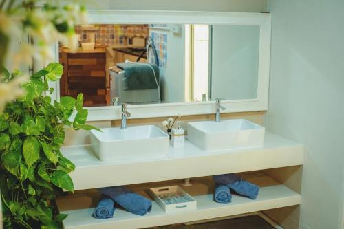 a bathroom with two sinks and a mirror at FA House by the Beach in Tanjung Bungah