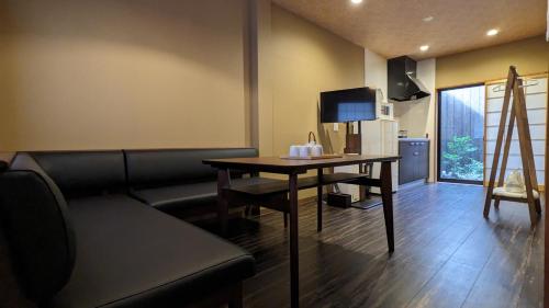 a living room with a table and a couch at Kyokoi Toujimikuni in Kyoto