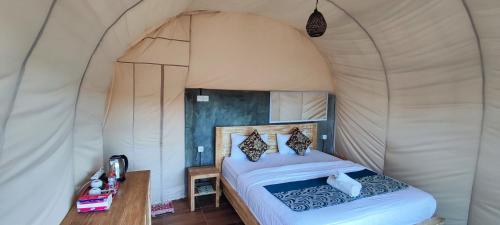 a bedroom with a bed in a tent at Villa Kedisan Lakeview in Kintamani