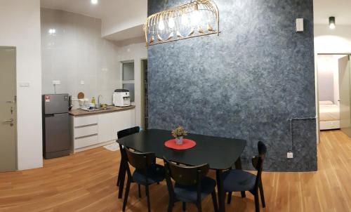 a dining room with a black table and chairs at G Residence - 2BR Family Suite Barrington Night Market - 3 in Brinchang