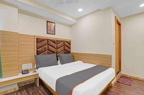 a bedroom with a large bed in a room at HOTEL STAY INN in Ahmedabad