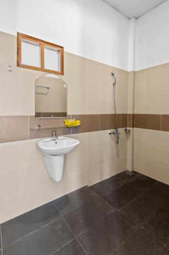 a bathroom with a sink and a mirror at Nhat Huy Bungalow Phu Quoc in Phú Quốc