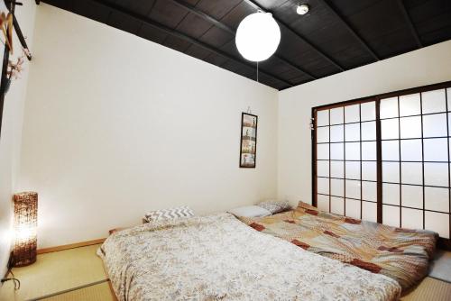 1 dormitorio con cama y ventana grande en Oyado Tofukuji en Kyoto